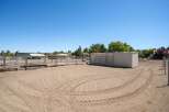 This property features a spacious outdoor arena with ample room for training and exercise, complete with sturdy metal fencing for safety.