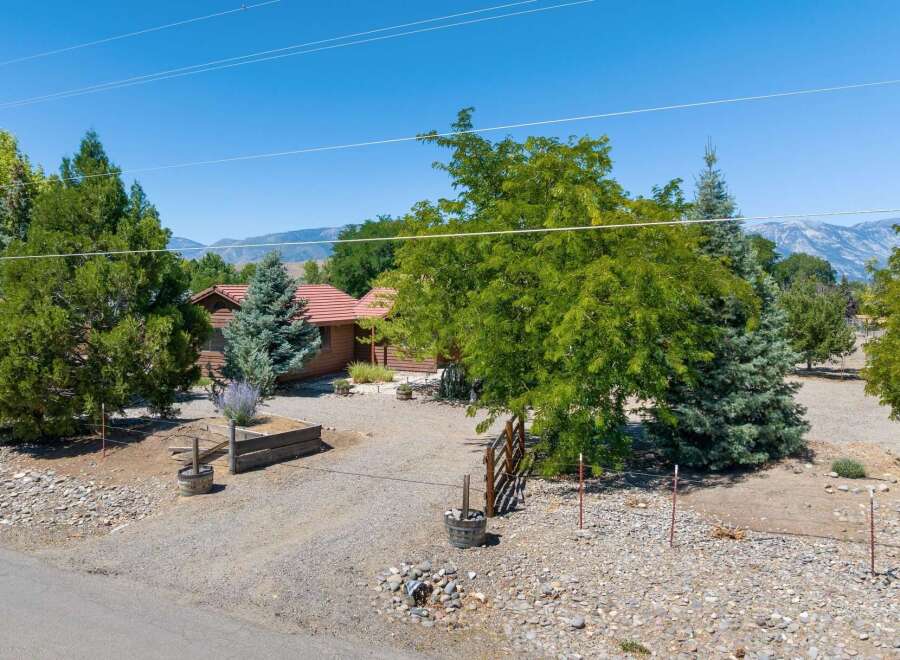 Nestled amidst mature trees and offering stunning mountain views, this charming property provides a serene retreat.