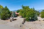 Nestled amidst mature trees and offering stunning mountain views, this charming property provides a serene retreat.