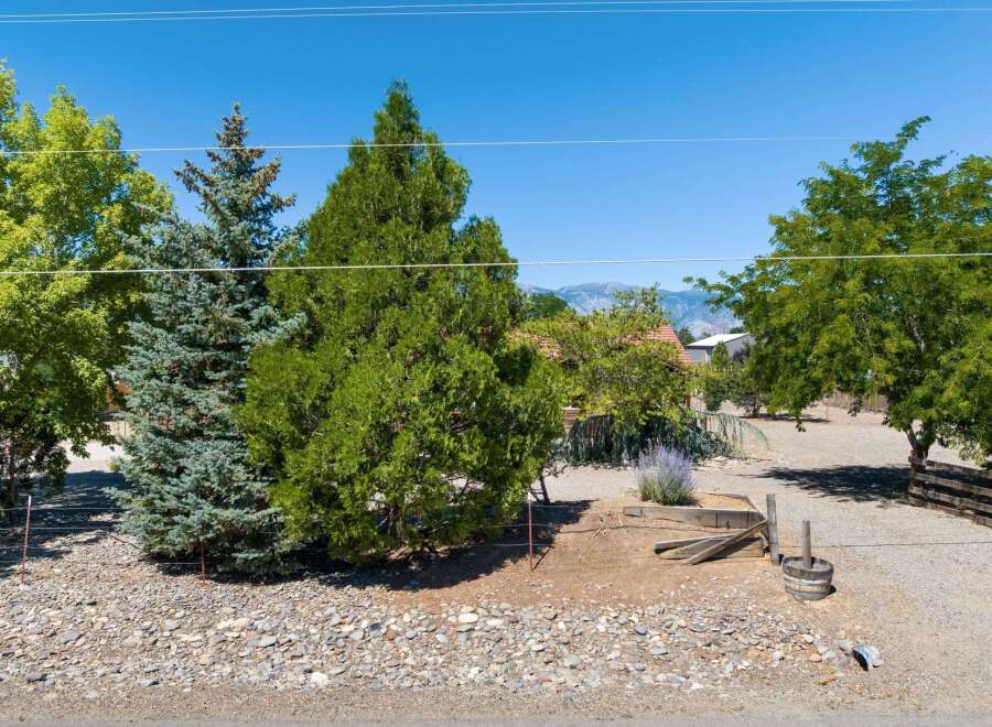 Discover this charming property featuring mature trees and a serene, natural landscape.