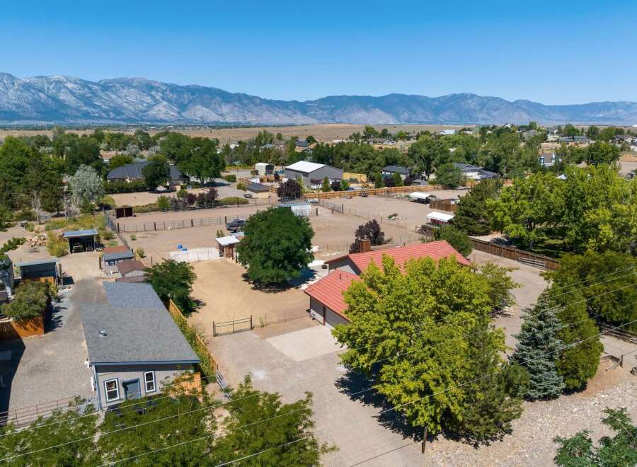 Discover this expansive property featuring a charming home with a red tile roof, perfect for those seeking a rural lifestyle.