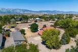 Discover this expansive property featuring a charming home with a red tile roof, perfect for those seeking a rural lifestyle.
