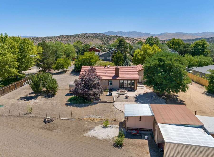 Discover this charming property featuring a cozy home with a red tile roof and a spacious backyard perfect for outdoor entertaining.