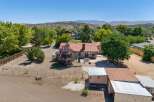 Discover this charming property featuring a cozy home with a red tile roof and a spacious backyard perfect for outdoor entertaining.