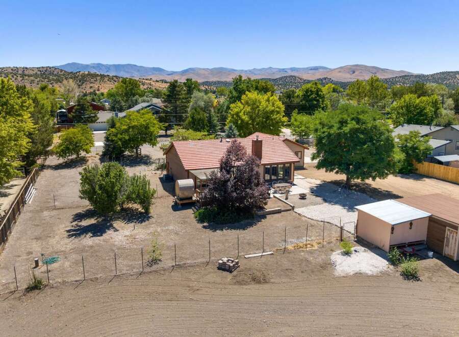 Discover this charming home nestled amidst mature trees and scenic mountain views.