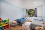 This charming bedroom features two twin beds, perfect for siblings or guests.