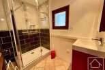 This modern bathroom features a spacious glass-enclosed shower with dual showerheads, perfect for a relaxing experience.