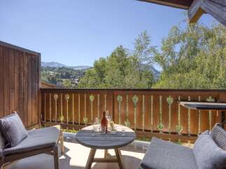 Enjoy breathtaking mountain views from this charming balcony, perfect for morning coffee or evening drinks.