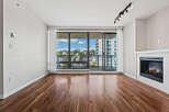 Experience modern living in this spacious apartment featuring a cozy fireplace and expansive windows that flood the space with natural light.
