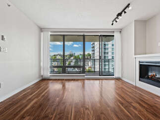 Experience modern living in this spacious apartment featuring a cozy fireplace and expansive windows that flood the space with natural light.