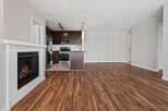 Experience modern living in this spacious open-concept home featuring a cozy fireplace and a sleek, contemporary kitchen.