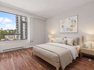 Experience modern urban living in this beautifully appointed bedroom, featuring a large window with stunning city views.