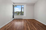 Experience modern living in this bright and airy room featuring a large window with stunning city views.