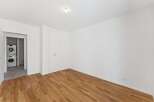 Discover this beautifully appointed room featuring gleaming hardwood floors and ample storage space with a built-in wardrobe.