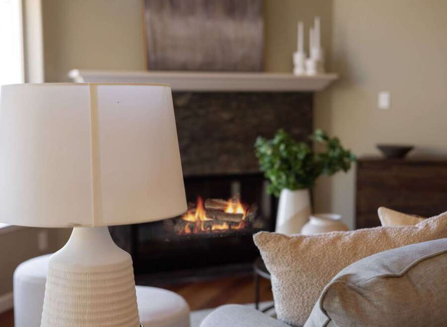Cozy up by the fireplace in this inviting living room, perfect for relaxing evenings.
