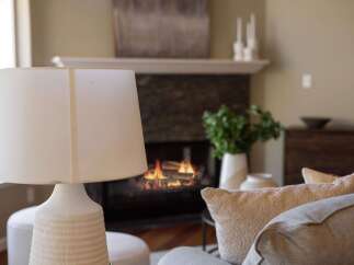 Cozy up by the fireplace in this inviting living room, perfect for relaxing evenings.