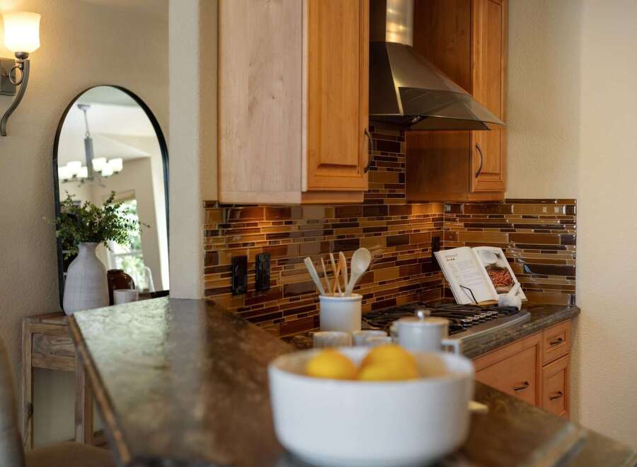 This kitchen features a beautiful mosaic tile backsplash that adds warmth and texture to the space.