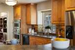This stunning kitchen boasts a sleek stainless steel double oven and a built-in dishwasher, perfect for any home chef.