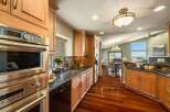 Experience luxury living in this stunning kitchen featuring sleek stainless steel appliances, granite countertops, and rich hardwood flooring.