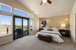 Experience breathtaking panoramic views from this stunning master bedroom, featuring expansive windows and a private balcony perfect for enjoying the scenery.