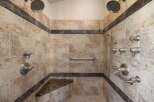 Experience ultimate relaxation in this luxurious custom shower, featuring dual shower heads, multiple body jets, and a convenient built-in bench.