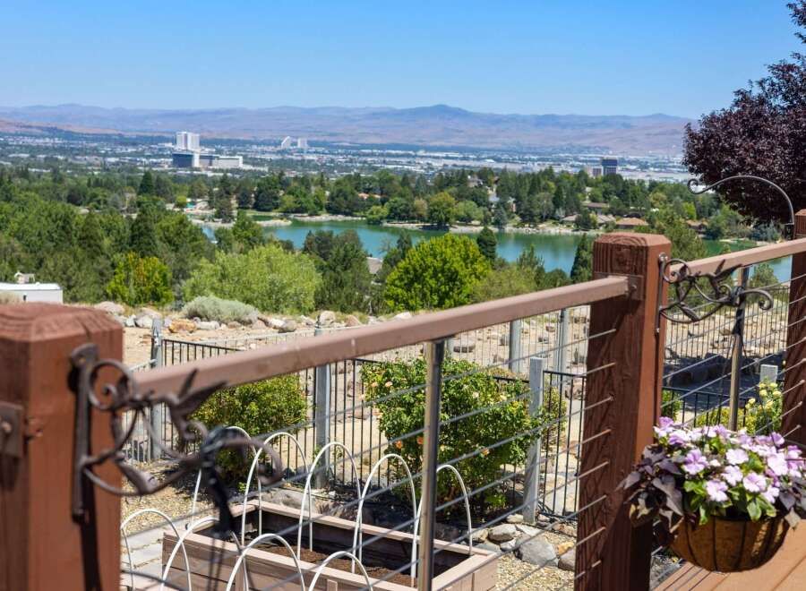 Enjoy breathtaking panoramic views of the city and a serene lake from this elevated property.
