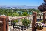 Enjoy breathtaking panoramic views of the city and a serene lake from this elevated property.