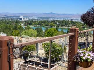 Enjoy breathtaking panoramic views of the city and a serene lake from this elevated property.