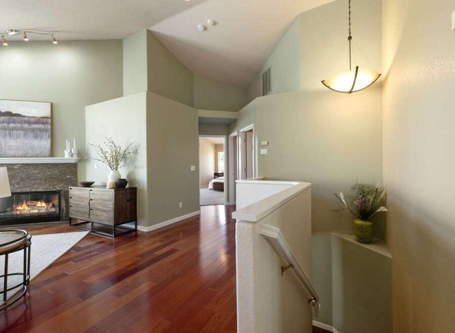 Step into this inviting entryway featuring a cozy fireplace and rich hardwood floors.