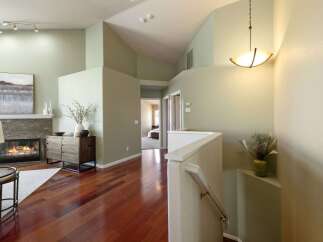 Step into this inviting entryway featuring a cozy fireplace and rich hardwood floors.