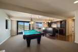 Enjoy endless entertainment in this spacious game room, complete with a professional pool table and a full-service bar.
