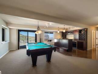 Enjoy endless entertainment in this spacious game room, complete with a professional pool table and a full-service bar.