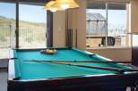 Enjoy endless entertainment in this home's dedicated game room, featuring a professional billiard table perfect for friendly competitions.