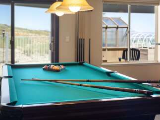 Enjoy endless entertainment in this home's dedicated game room, featuring a professional billiard table perfect for friendly competitions.
