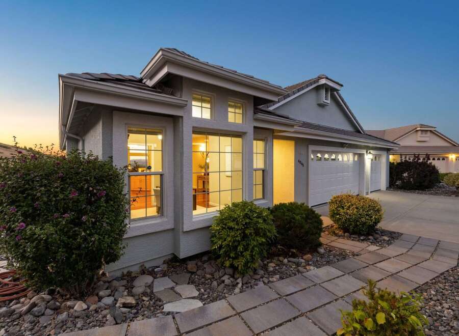 Discover this charming home featuring a welcoming facade with large windows that illuminate the interior.