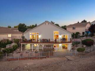 Experience outdoor living at its finest with this stunning home featuring a spacious deck perfect for entertaining and enjoying the twilight views.