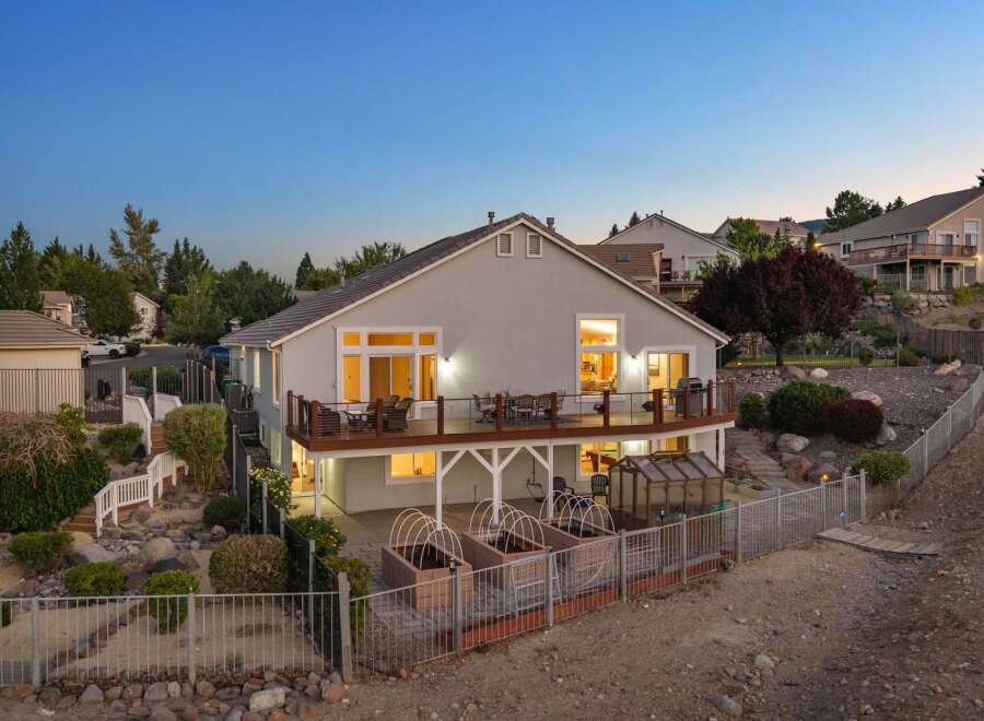 Experience luxurious outdoor living with this stunning multi-level deck, perfect for entertaining or enjoying the serene evening sky.