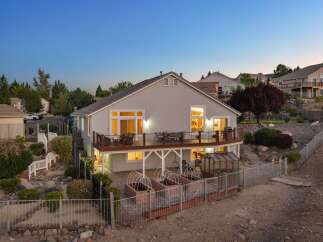 Experience luxurious outdoor living with this stunning multi-level deck, perfect for entertaining or enjoying the serene evening sky.