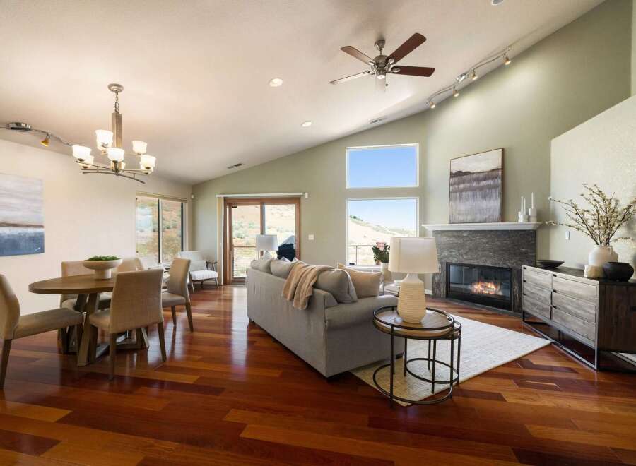 Experience modern living in this spacious open-concept great room, featuring a vaulted ceiling and abundant natural light.