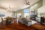 Experience modern living in this spacious open-concept great room, featuring a vaulted ceiling and abundant natural light.