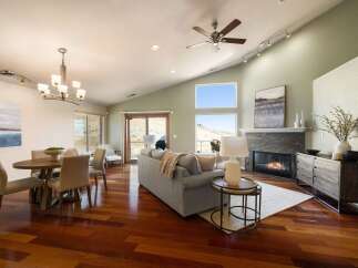 Experience modern living in this spacious open-concept great room, featuring a vaulted ceiling and abundant natural light.