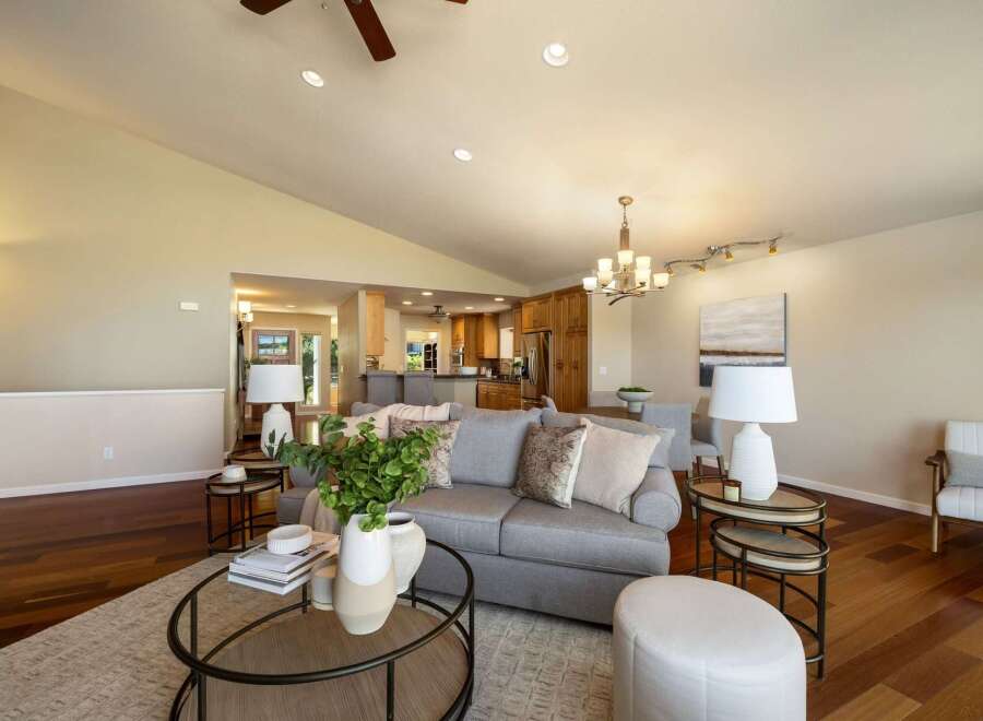 Experience open-concept living in this beautifully appointed home, featuring a spacious living area that seamlessly flows into a modern kitchen and dining space.