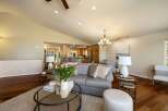Experience open-concept living in this beautifully appointed home, featuring a spacious living area that seamlessly flows into a modern kitchen and dining space.