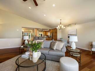 Experience open-concept living in this beautifully appointed home, featuring a spacious living area that seamlessly flows into a modern kitchen and dining space.