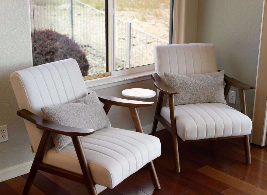 Relax in comfort and style in this inviting living space, featuring two plush armchairs perfect for quiet reading or conversation.