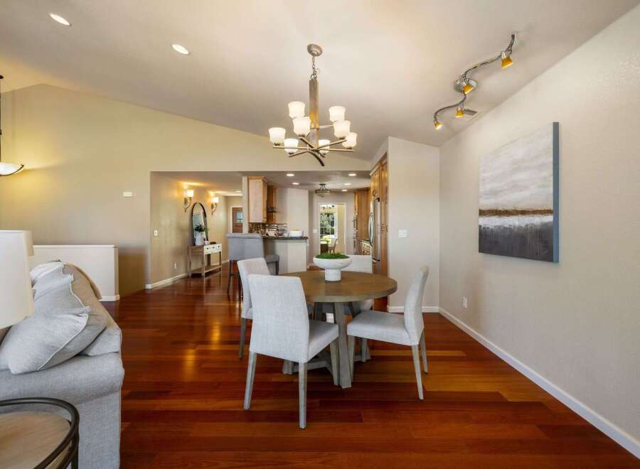 Experience elegant dining in this beautifully appointed space, featuring a round wooden table with four upholstered chairs, perfect for intimate gatherings.