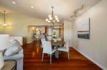 Experience elegant dining in this beautifully appointed space, featuring a round wooden table with four upholstered chairs, perfect for intimate gatherings.
