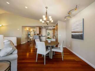 Experience elegant dining in this beautifully appointed space, featuring a round wooden table with four upholstered chairs, perfect for intimate gatherings.