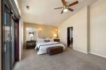 Experience ultimate comfort in this spacious master bedroom, featuring a vaulted ceiling and a modern ceiling fan for optimal air circulation.