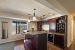 Entertain in style in this stunning home bar area, complete with a granite-topped island and a built-in wine rack.